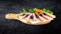 Sliced ham salami decorated on wooden board with olives, tomato Royalty Free Stock Photo