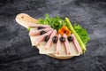Sliced ham salami decorated on wooden board with olives, tomato and lettuce and clipping path Royalty Free Stock Photo