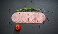 Sliced ham sausage on a stone background Royalty Free Stock Photo