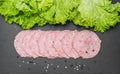 Sliced ham sausage on a stone background Royalty Free Stock Photo