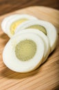 Sliced hard boiled egg on cutting board Royalty Free Stock Photo