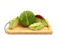 Sliced head of cabbage and red chili pepper on a cutting board on a light background. Royalty Free Stock Photo