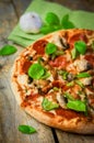 Sliced home made pepperoni pizza on wooden rustic background