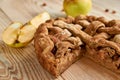 Sliced homemade american apple pie with fresh apples on brown wooden table. Homemade classical fruit tart with raisins