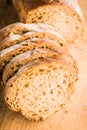 Sliced homemade bread on the wooden cutting board. Selective focus. Shallow depth of field Royalty Free Stock Photo