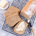 Sliced homemade no knead sandwich bread with butter, on cooling rack, top view, square Royalty Free Stock Photo