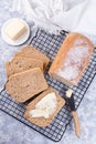 Sliced homemade no knead sandwich bread with butter, on cooling rack, vertical, top view Royalty Free Stock Photo