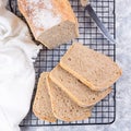 Sliced homemade sandwich bread on cooling rack, top view, square format Royalty Free Stock Photo