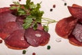 Sliced horse sausage, herbs and spices on cutting board. Selective focus Royalty Free Stock Photo