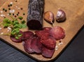 Sliced horse sausage, herbs and spices on cutting board. Selective focus. Shallow depth of field Royalty Free Stock Photo