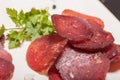 Sliced horse sausage, herbs and spices on cutting board. Selective focus. Shallow depth of field Royalty Free Stock Photo