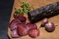 Sliced horse sausage, herbs and spices on cutting board. Selective focus. Shallow depth of field Royalty Free Stock Photo