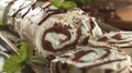 sliced ice cream roll with chocolate curls and mint leaves on top, on a wooden board, poster Royalty Free Stock Photo