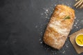 Sliced Italian ciabatta bread on black background. Top view, flat lay. Royalty Free Stock Photo