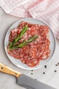 Sliced italian salami sausage with peppercorn on plate
