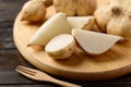 Sliced jicama or yam on chopping wooden board