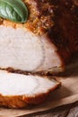 Sliced juicy baked pork fillet macro on an old table vertical Royalty Free Stock Photo