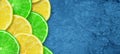 Sliced juicy lime and lemon on a concrete dark blue background. Copy space. Fresh fruits. Fruit background. Healthy food. Vitamins Royalty Free Stock Photo