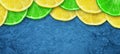 Sliced juicy lime and lemon on a concrete dark blue background. Copy space. Fresh fruits. Fruit background. Healthy food. Vitamins Royalty Free Stock Photo