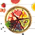 Sliced juicy watermelon pizza on white wooden table. Royalty Free Stock Photo