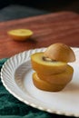 Sliced kiwi fruit on a white plate, close-up of golden kiwi fruit Royalty Free Stock Photo