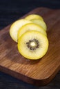 Sliced kiwi fruit on wooden board, close-up of golden kiwi fruit Royalty Free Stock Photo
