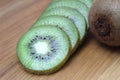 Sliced kiwi lies on a wooden table