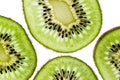 Sliced kiwifruit rings on white background top view macro