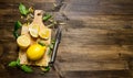 Sliced lemon on the board with leaves. Royalty Free Stock Photo