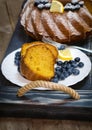 Sliced lemon cake with blueberries on a tray. Royalty Free Stock Photo