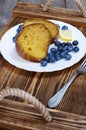 Sliced lemon cake with blueberries on wooden tray Royalty Free Stock Photo