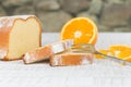 Sliced lemon cake with a fork and some fresh orange fruit slices Royalty Free Stock Photo