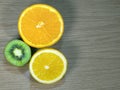 Sliced lemon, kiwi, orange on wood background Royalty Free Stock Photo