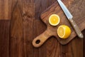 Sliced lemon and knife on wooden board on table with copyspace Royalty Free Stock Photo