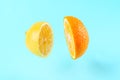 Sliced lemon orange on blue background with levitation effect, art fruit minimal Royalty Free Stock Photo