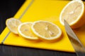 Sliced lemon on a yellow cutting board Royalty Free Stock Photo