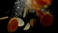 Sliced lemons and oranges falling into the water