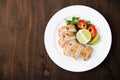 Sliced lime pork tenderloin on dark wooden background top view