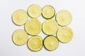 Sliced lime ringlets lie on a white background