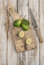 Sliced limes on a wooden cutting board on a table Royalty Free Stock Photo