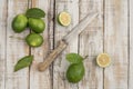 Sliced limes and knife on a wooden table Royalty Free Stock Photo