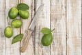 Sliced limes and knife on  wooden table Royalty Free Stock Photo