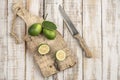 Sliced limes on a wooden cutting board on a table Royalty Free Stock Photo