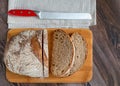 Sliced loaf of rye bread with a knife on a cutting board Royalty Free Stock Photo