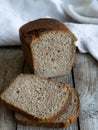 sliced loaf rye bread on a wooden board. Close up. Copy space. Rustic Royalty Free Stock Photo