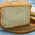 Sliced loaf of white bread on a wooden cutting board. Royalty Free Stock Photo