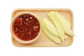 Sliced mango with a sweet sauce made with sugar, chilli, shrimp paste, paprika and onion on wood tray isolated on white background