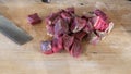 Sliced meat and a knife on a chopping board close-up. Raw meat for cooking. Fresh raw stir fry beef strips. Royalty Free Stock Photo