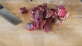 Sliced meat and a knife on a chopping board close-up. Raw meat for cooking. Fresh raw stir fry beef strips. Royalty Free Stock Photo