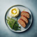 Sliced meatloaf with mashed potatoes and green beans on a plate